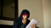 In this Wednesday, April 3, 2019, photo, Kimberly Gwen Polman, a Canadian national, reads a letter at camp Roj in Syria.