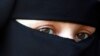 FILE - A protestor attends a demonstration against the ban on Muslim women wearing the burqa in public in The Hague, Netherlands.