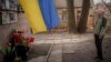 Oleksandr Turovskyi, whose son Sviatoslav was among eight men executed in Bucha, Ukraine, in March 2022, takes a moment on March 30, 2024, at a memorial where his son's body was found. The United Nations accused Russia on April 2 of serious violations of human rights in Ukraine.