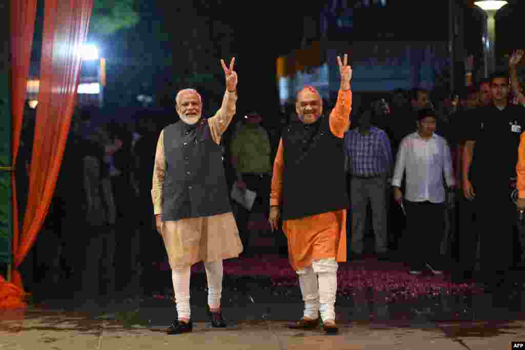 Indian Prime Minister Narendra Modi (L) and president of the ruling Bharatiya Janata Party (BJP) Amit Shah celebrate victory in India's general elections, in New Delhi.