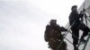 Members of Comando de Operaciones Especiales, or National Police Special Operations Command, take position on the roof of a building in Cartagena, Colombia, April 12, 2012.