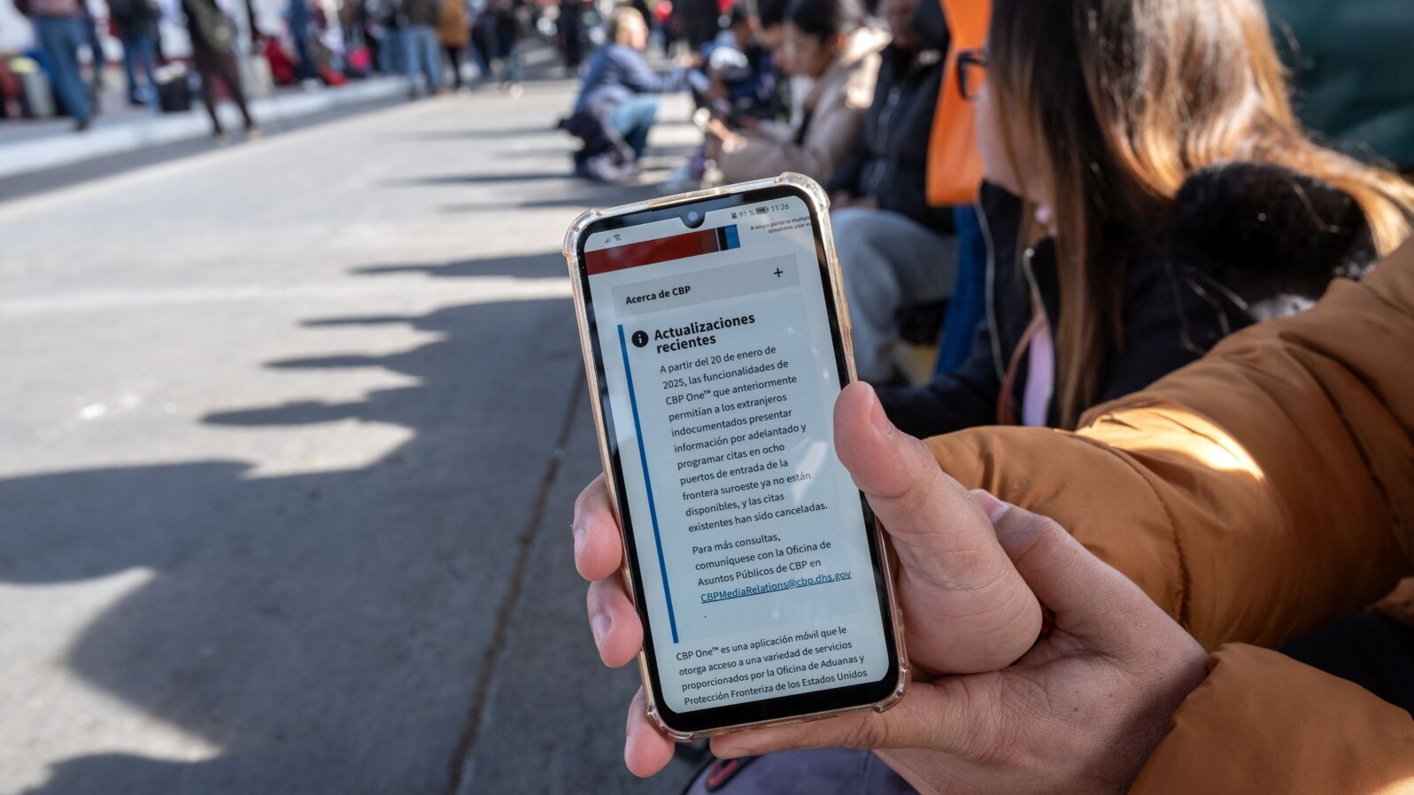 An asylum seeker shows an updated message on the CBP One app mentioning that all appointments have been cancelled as they wait for their CBP One appointment with U.S. authorities before crossing through El Chaparral port in Tijuana, Baja California state, Mexico, Jan. 20, 2025. 
