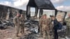 U.S. soldiers stand amid damage at a site of Iranian bombing at Ain al-Asad air base, in Anbar, Iraq, Jan. 13, 2020. 