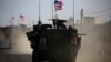 A convoy of U.S. forces armored vehicles drives near the village of Yalanli, on the western outskirts of the northern Syrian city of Manbij, March 5, 2017.