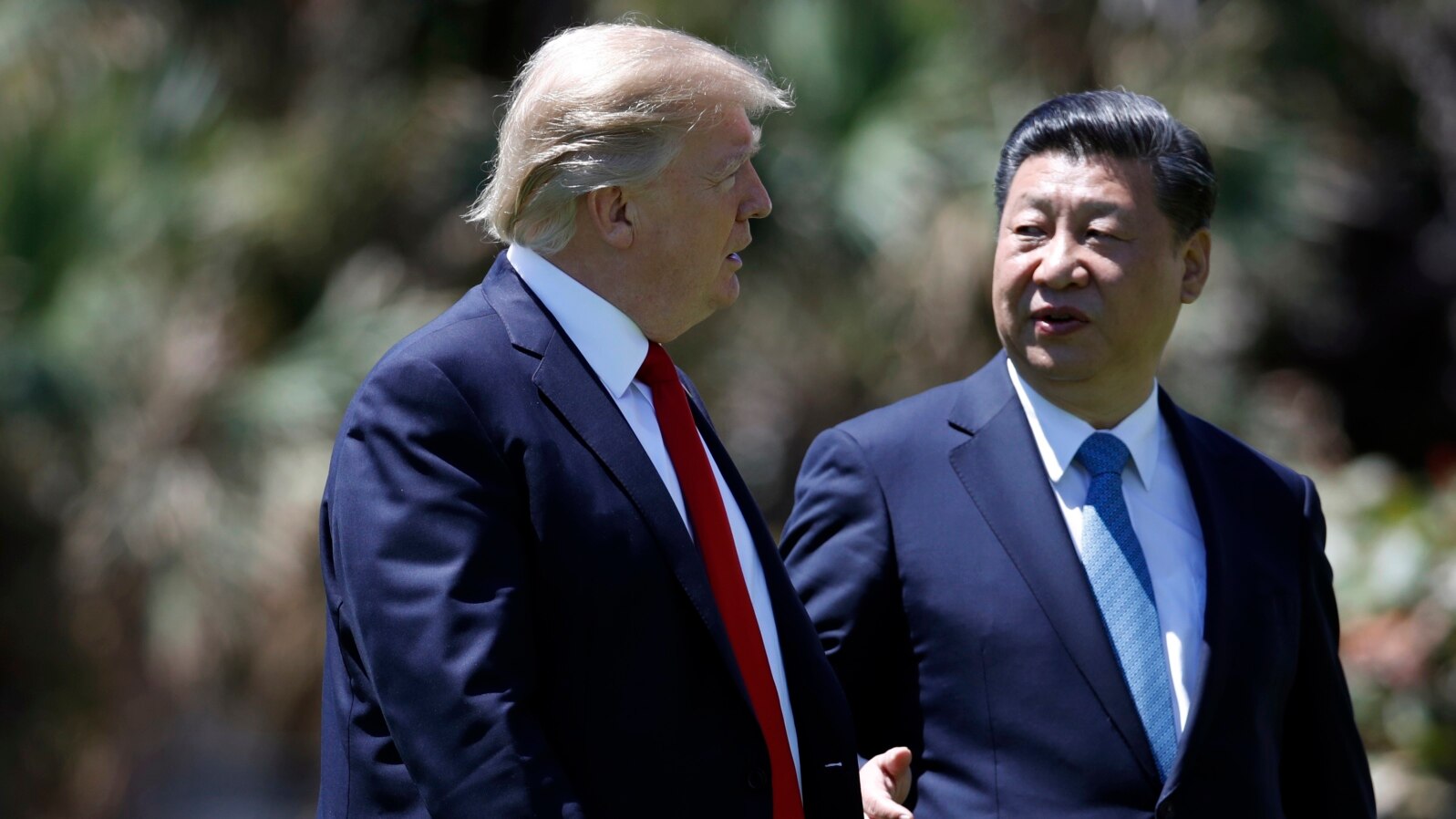 President Donald Trump and Chinese President Xi Jinping walk together after their meetings at Mar-a-Lago, April 7, 2017, in Palm Beach, Florida. 