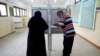 People cast their ballots at a school used as a polling station during the second round of Egypt's parliamentary elections, in Cairo, Egypt, Nov. 7, 2020. 
