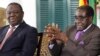 Zimbabwean President Robert Mugabe (R) and Prime Minister Morgan Tsvangirai announce the resolution of longstading disputes over a draft constitution at a press conference in Harare, January 17, 2013.