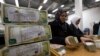 FILE - Employees stack Syrian currency in the Central Bank, in Damascus, Syria, Jan. 13, 2010. 