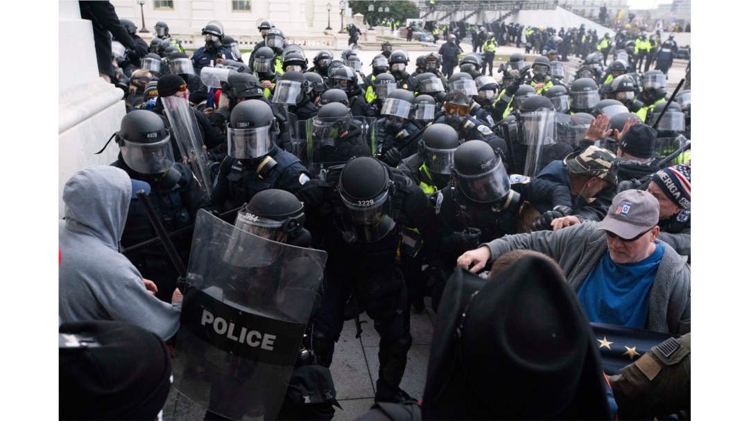 FILE - U.S. Capitol Police push back rioters trying to enter the Capitol in Washington, Jan. 6, 2021.