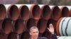 President Barack Obama waves as he arrives at the TransCanada Stillwater Pipe Yard in Cushing, Oklahoma, March, 22, 2012.
