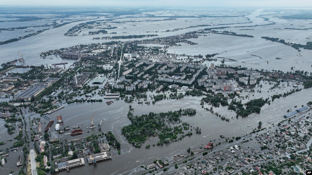 Houses are seen underwater and polluted by oil in a flooded neighbourhood in Kherson, Ukraine, Saturday, June 10, 2023. (AP Photo)