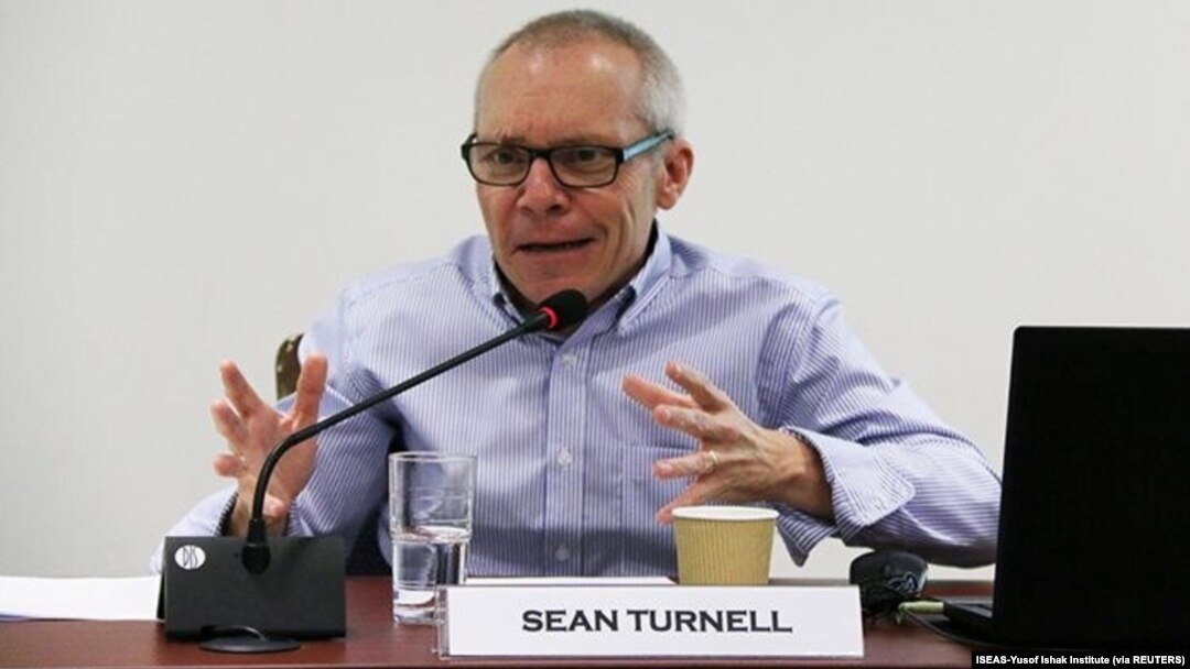 FILE - Sean Turnell discusses economic reforms by Myanmar's NLD government at a seminar in Singapore, May 2018.