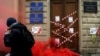 FILE - A protester walks past a defaced entrance of Russian government media watchdog Roskomnadzor's office, in central St. Petersburg, March 10, 2019.