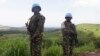 FILE - U.N. peacekeepers from Tanzania hold their weapons as they patrol outside Goma during a visit by officials from the U.N. Security Council in the eastern Democratic Republic of Congo, October 2013.