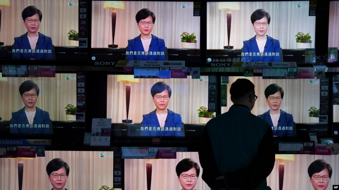 A man watches the television message that Hong Kong Chief Executive Carrie Lam makes an announcement on the extradition bill, at a home electronics retailer in Hong Kong, on Wednesday, Sept. 4, 2019. Chief Executive Lam has announced the government…