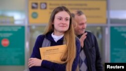 Convicted Russian agent Maria Butina, who was released from a Florida prison and then deported by U.S. immigration officials, meets with journalists upon her arrival at Sheremetyevo International Airport outside Moscow, Russia, Oct. 26, 2019.