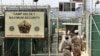 FILE - Military guards walk within Camp Delta, at the Guantanamo Bay U.S. Naval Base, Cuba.