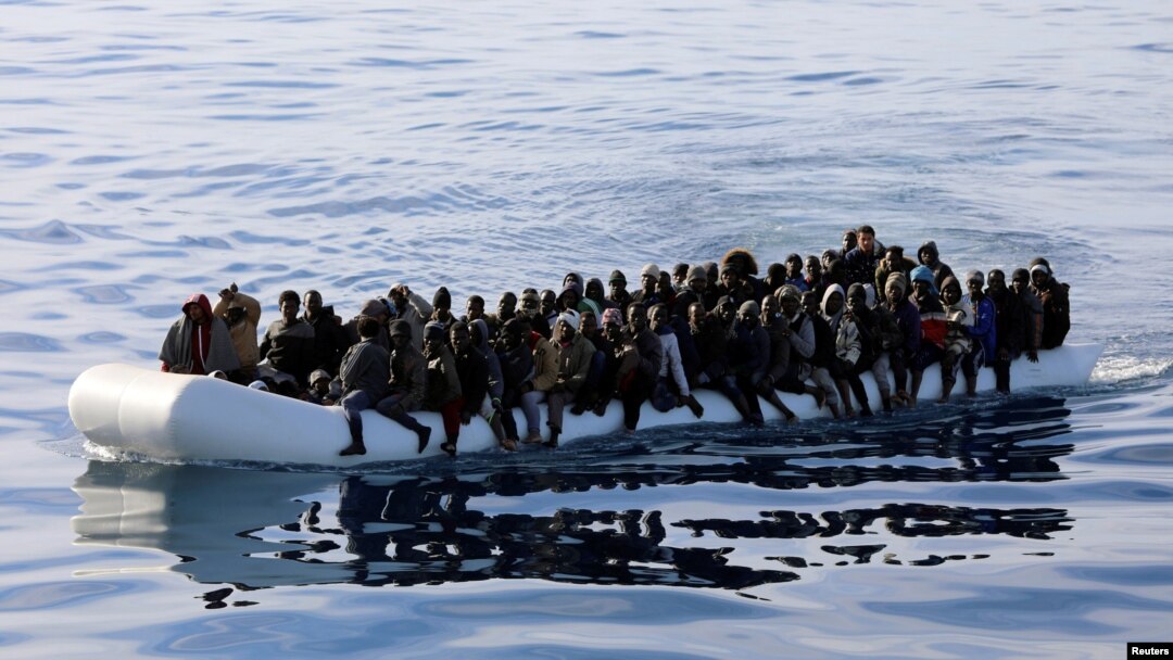 FILE - Migrants are seen in a rubber dinghy as they are rescued by the Libyan coast guard in the Mediterranean Sea off the coast of Libya, Jan. 15, 2018. Doctors Without Borders reported Monday that more than 100 migrants in two rubber boats died off the coast of Libya in early September.