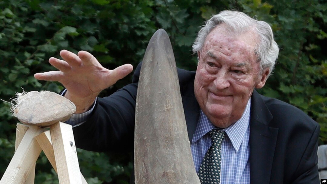 FILE - Richard Leakey, Kenyan wildlife conservationist, places a rhino horn to be burned at the zoo in Dvur Kralove, Czech Republic, Sept. 19, 2017. 