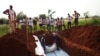 Workers from the Central African Red Cross bury 13 victims of sectarian violence in a mass grave, in Bangui, Central African Republic, Jan. 5, 2014. 