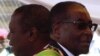 Zimbabwean President Robert Mugabe (R) and Prime Minister Morgan Tsvangirai arrive at a rally marking Zimbabwe's 31st independence anniversary celebrations in Harare, Zimbabwe, April 18, 2011. 