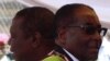 Zimbabwean President Robert Mugabe (R) and Prime Minister Morgan Tsvangirai arrive at a rally marking Zimbabwe's 31st independence anniversary celebrations in Harare, Zimbabwe, April 18, 2011. 