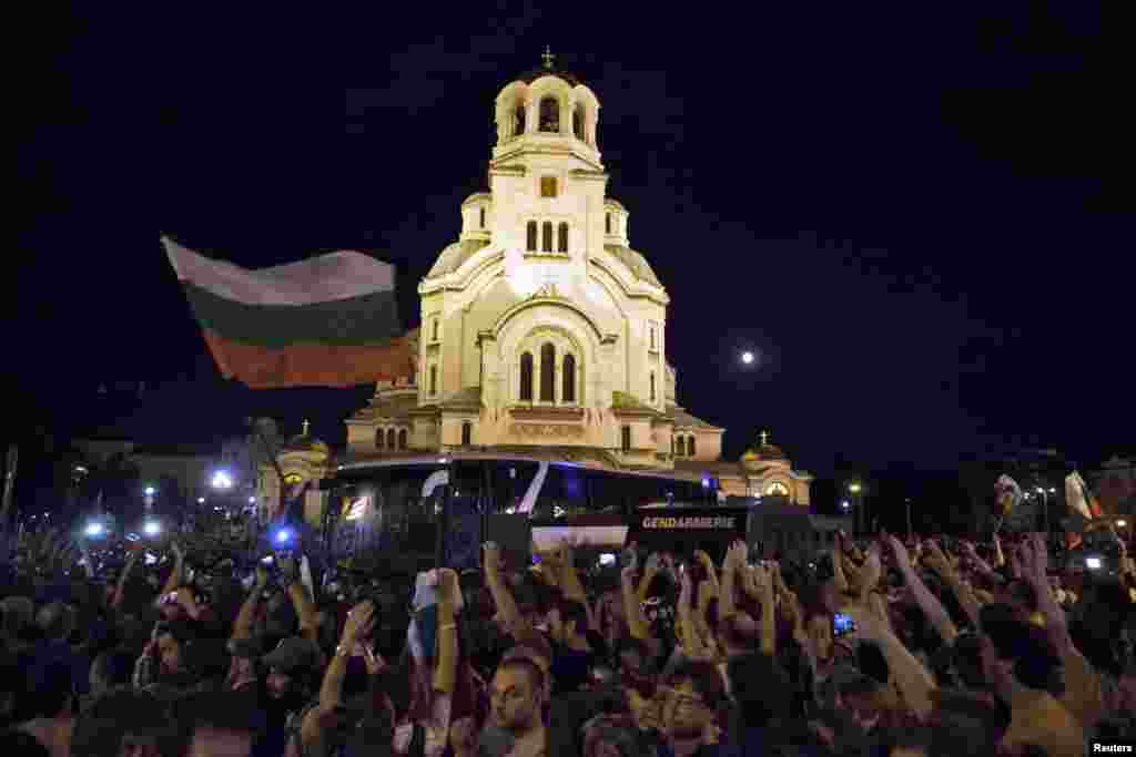 Protesters throw objects at a heavily guarded bus transporting deputies out of parliament where they had been discussing budget measures, Sofia, Bulgaria, July 23, 2013.