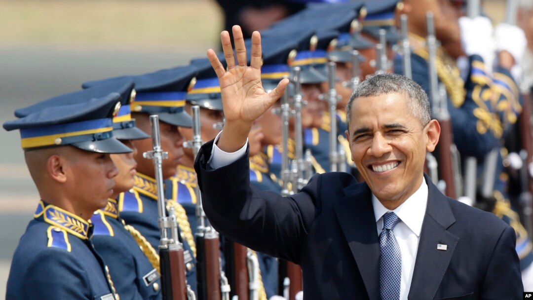 President Barack Obama waves to the media upon arrival Monday at the Ninoy Aquino International Airport in Manila, Philippines, April 28, 2014.