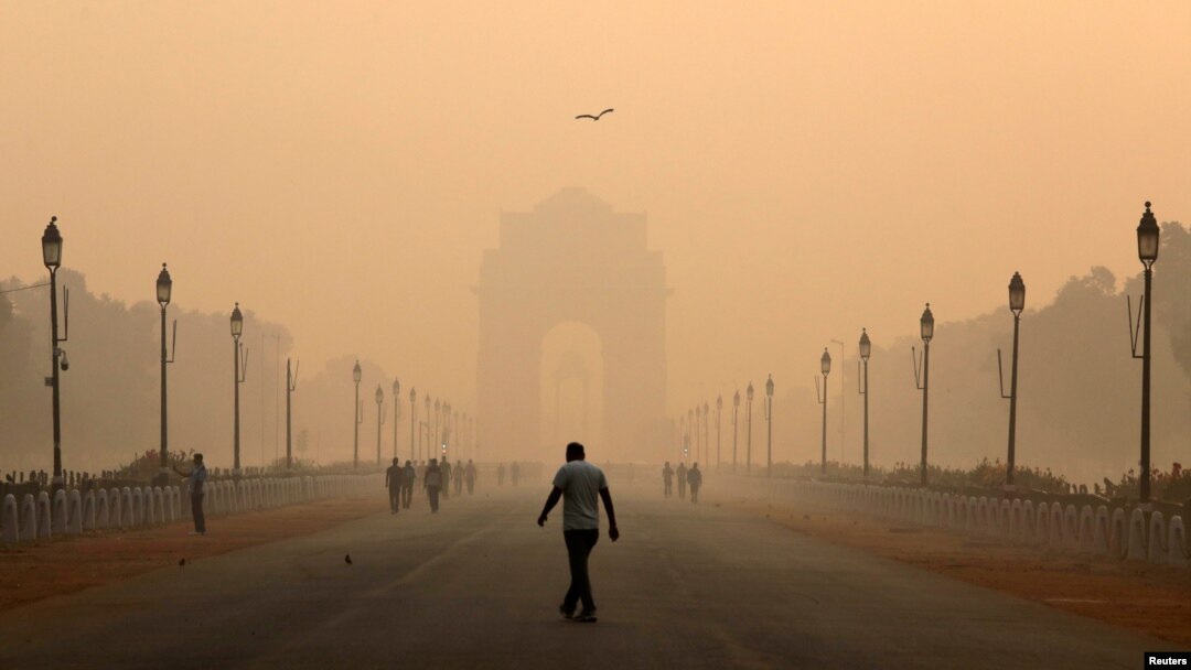 A man walks in front of the India Gate shrouded in smog in New Delhi, India, Oct. 29, 2018.