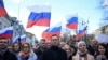 FILE - Russian opposition leader Alexei Navalny, his wife Yulia, opposition politician Lyubov Sobol and other demonstrators march in memory of murdered Kremlin critic Boris Nemtsov in downtown Moscow, Feb. 29, 2020. 