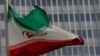 FILE - An Iranian flag flutters in front of the International Atomic Energy Agency (IAEA) headquarters in Vienna, Austria, Sept. 9, 2019. 