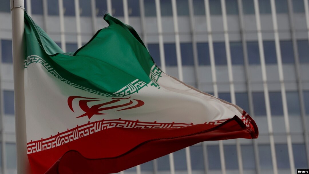 FILE - An Iranian flag flutters in front of the International Atomic Energy Agency (IAEA) headquarters in Vienna, Austria, Sept. 9, 2019.