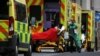FILE - Medical workers transport a patient from an ambulance at the Royal London Hospital amidst the spread of the coronavirus disease (COVID-19) pandemic, in London, Jan. 10, 2021.