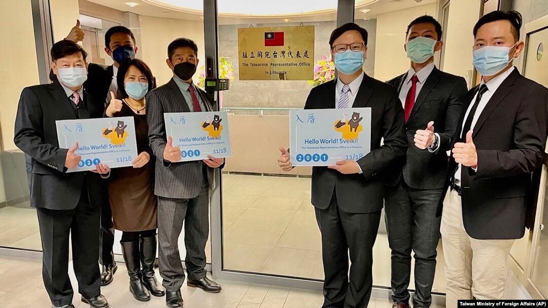 Eric Huang, newly appointed director to the representative office, third from right, poses with other staffers outside the Taiwan Representative Office in Vilinius, Lithuania, Nov. 18, 2021.