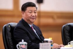 FILE - Chinese President Xi Jinping attends a meeting at the Great Hall of the People in Beijing, China, June 25, 2019.