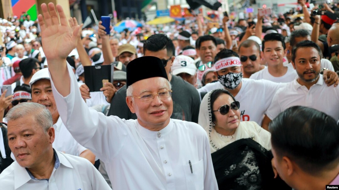 FILE - Former Malaysian Prime Minister Najib Razak and his wife, Rosmah Mansor, attend the Anti-ICERD (International Convention on the Elimination of All Forms of Racial Discrimination) mass rally in Kuala Lumpur, Malaysia, Dec. 8, 2018.