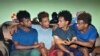 Eritrean under-20 soccer players Hermon Fessehaye Yohannes, Simon Asmelash Mekonen, Hanibal Girmay Tekle, and Mewael Tesfai Yosief talk together in a house where they are staying in Uganda.
