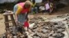 FILE - Alice Jallabah, head of a bushmeat seller group, holds dried bushmeat on Oct. 7, 2014, in Monrovia. The outbreak of the Ebola virus in Liberia led to a ban on eating bushmeat.