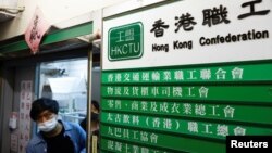 A man walks out of a Hong Kong Confederation of Trade Unions (HKCTU) office, in Hong Kong, China, Sept. 19, 2021.