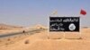 FILE - An Islamic State group poster is seen in the Syrian town of al-Sukhnah, Aug. 13, 2017.