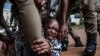 FILE - Stella Nyanzi, a prominent Ugandan activist, is arrested by police on May 18, 2020, after she organized a protest for more food distribution by the government to people who have been financially struggling because of the nationwide lockdown.