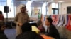 Hadi Alajmi, president of IUSB's International Student Organization, speaks with Thanksgiving attendees. (Esha Sarai/VOA)