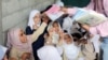 Students receive books in their class at the teacher's house, who turned it into a makeshift free school that hosts 700 students, in Taiz, Yemen, Oct. 18, 2018. 