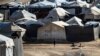 FILE - Children play among tents at the Kurdish-run al-Hol camp, in the northeastern Syrian Hasakeh governorate, Feb. 17, 2021. Many of the families released from the camp have struggled to make a new life in their hometown of Sarrin, Syria. 