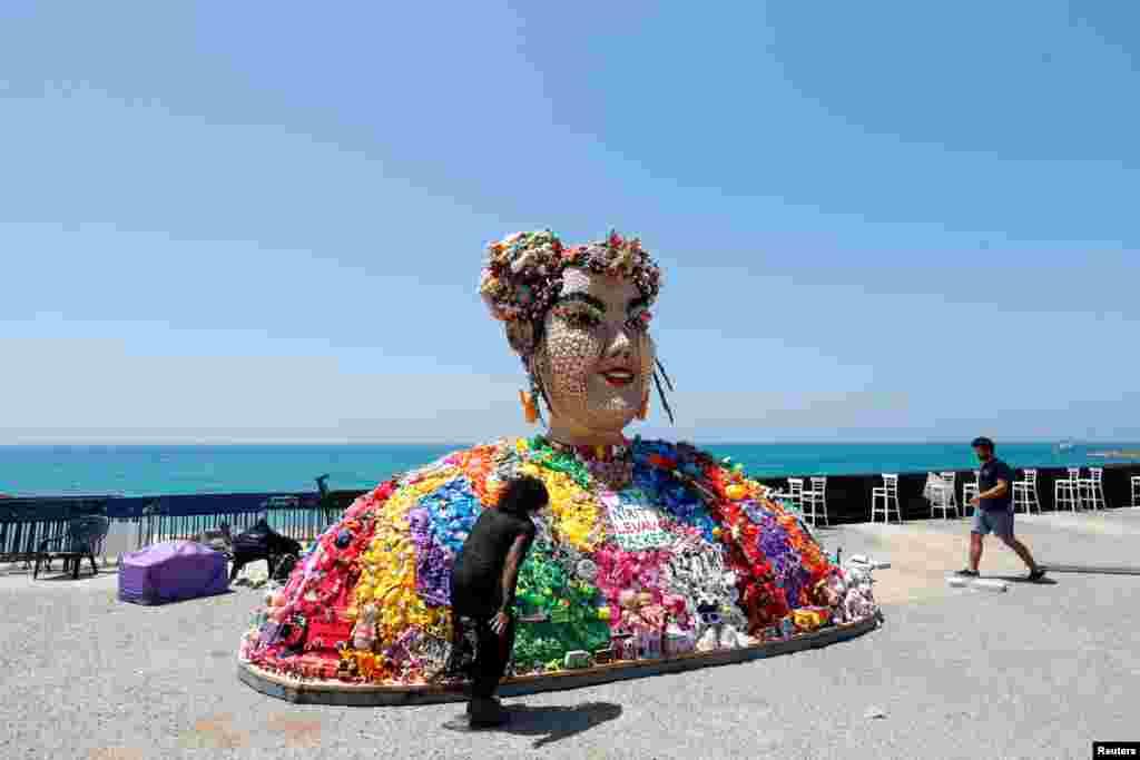 Israeli artist Nirit Levav Packer looks at her artwork entitled "Toy", the name of the last year's Eurovision Song Contest winning song by Israel's Netta Barzilai, as the opening ceremony of this year's contest begins tonight, in Tel Aviv.