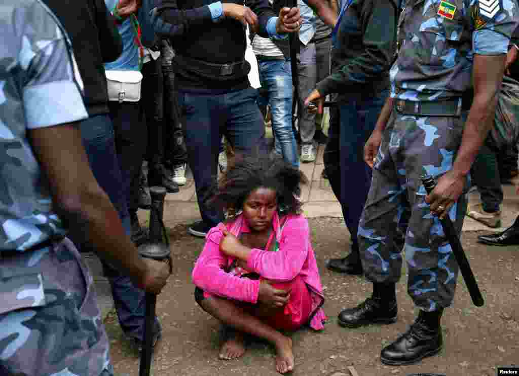 Ethiopian Federal Police officers detain a woman suspected to be carrying explosives during the welcoming ceremony of Jawar Mohammed, U.S.-based Oromo activist and leader of the Oromo Protests, in Addis Ababa, Aug. 5, 2018.