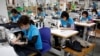 FILE - Women are seen working at Maxport, an export garment factory in Hanoi, Vietnam, March 20, 2019. 