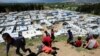 FILE - Syrian refugee children play together, as Lebanon extends a lockdown to combat the spread of the coronavirus disease (COVID-19) at a Syrian refugee camp in the Bekaa valley, Lebanon May 7, 2020. 