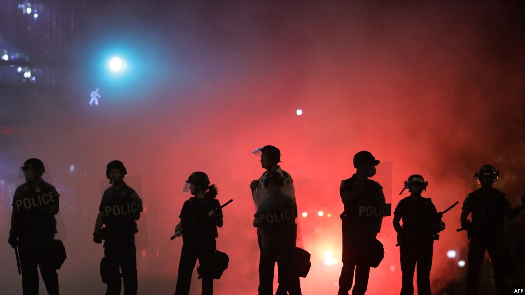 FILE - Police hold a perimeter near the White House as demonstrators gather to protest the killing of George Floyd in the morning hours on May 31, 2020 in Washington, D.C.