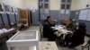 Polling station worker count ballots at a polling station Dec.12, 2019 in Algiers. 